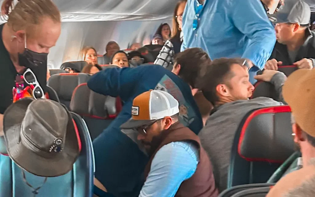 passengers-restrain-man-attempting-to-open-plane-door-mid-flight