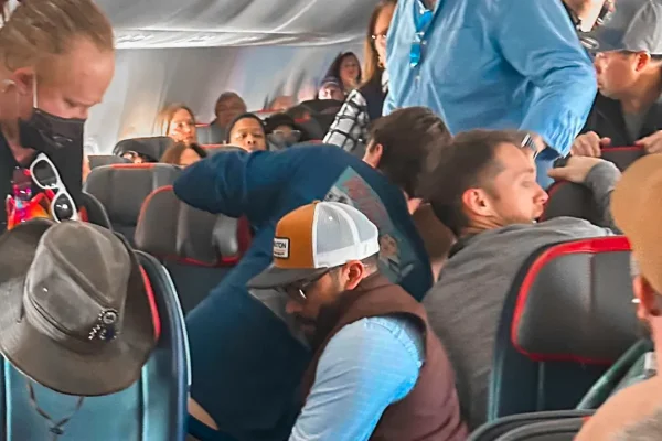 passengers-restrain-man-attempting-to-open-plane-door-mid-flight